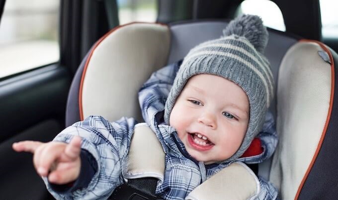 baby in car seat with coat on 1